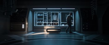 Movie still from “Oblivion” (2013), directed by Joseph Kosinski – A man is walking in front of a kitchen; Wide shot, High angle