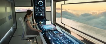 Movie still from “Oblivion” (2013), directed by Joseph Kosinski – A woman sitting in front of a computer screen; Wide shot, High angle