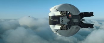 Movie still from “Oblivion” (2013), directed by Joseph Kosinski – View of a helmet on the side of a plane; Extreme Wide shot, Low angle