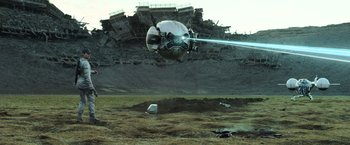 Movie still from “Oblivion” (2013), directed by Joseph Kosinski – An image of an airplane that is flying in the air; Extreme Wide shot, Low angle
