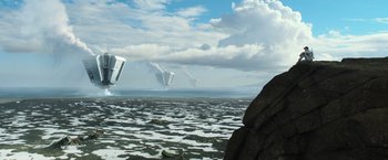 Movie still from “Oblivion” (2013), directed by Joseph Kosinski – An image of an ocean with a bunch of buildings in the background; Extreme Wide shot, Low angle