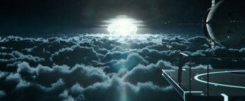 Movie still from “Oblivion” (2013), directed by Joseph Kosinski – A view of the sun from above the clouds at night time; Extreme Wide shot, Low angle