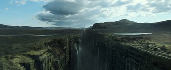 Movie still from “Oblivion” (2013), directed by Joseph Kosinski – An image of a waterfall in the middle of a valley; Extreme Wide shot, Overhead angle