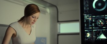 Movie still from “Oblivion” (2013), directed by Joseph Kosinski – A woman standing in front of a window looking down; Close Up shot, Low angle
