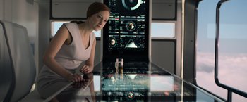 Movie still from “Oblivion” (2013), directed by Joseph Kosinski – A woman sitting in front of a computer screen; Medium shot, Low angle