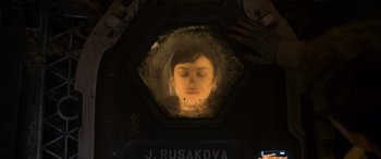 Movie still from “Oblivion” (2013), directed by Joseph Kosinski – A person is looking out of a window at night; Close Up shot, Overhead angle