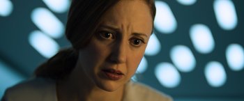 Movie still from “Oblivion” (2013), directed by Joseph Kosinski – A person with a sad look on their face; Close Up shot, Over the shoulder angle