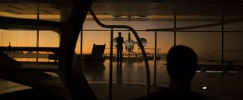 Movie still from “Oblivion” (2013), directed by Joseph Kosinski – A man standing in front of an airplane in an airport; Wide shot, Low angle