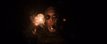 Movie still from “Oblivion” (2013), directed by Joseph Kosinski – An older man wearing sunglasses and holding a lit cigarette; Close Up shot, Low angle