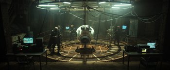 Movie still from “Oblivion” (2013), directed by Joseph Kosinski – A group of people standing around a machine; Extreme Wide shot, High angle