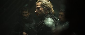 Movie still from “Oblivion” (2013), directed by Joseph Kosinski – A person wearing a suit of armor; Close Up shot, Over the shoulder angle