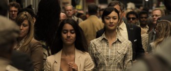 Movie still from “Oblivion” (2013), directed by Joseph Kosinski – Two young women are standing in a crowd of onlookers; Close Up shot, Over the shoulder angle