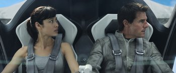 Movie still from “Oblivion” (2013), directed by Joseph Kosinski – A man and a woman sitting next to each other in a car; Close Up shot, Overhead angle