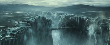Movie still from “Oblivion” (2013), directed by Joseph Kosinski – A view of a bridge that is over a waterfall; Extreme Wide shot, High angle