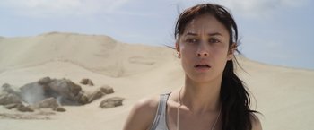 Movie still from “Oblivion” (2013), directed by Joseph Kosinski – A woman standing on top of a sand dune; Close Up shot, High angle