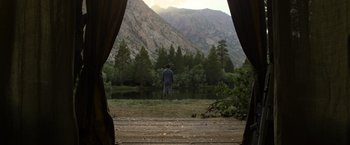 Movie still from “Oblivion” (2013), directed by Joseph Kosinski – A man standing in front of a body of water; Extreme Wide shot, Low angle