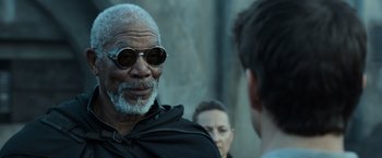 Movie still from “Oblivion” (2013), directed by Joseph Kosinski – An older man wearing sunglasses talking to a younger man; Close Up shot, Over the shoulder angle