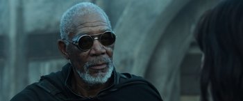 Movie still from “Oblivion” (2013), directed by Joseph Kosinski – An older man wearing sunglasses and a black jacket; Close Up shot, Low angle
