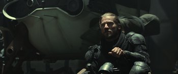 Movie still from “Oblivion” (2013), directed by Joseph Kosinski – A man with a beard is sitting in a car; Close Up shot, Low angle
