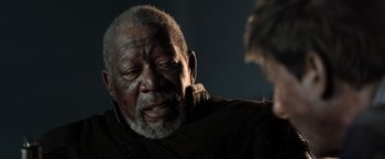 Movie still from “Oblivion” (2013), directed by Joseph Kosinski – An older man with a beard and a mustache; Close Up shot, Over the shoulder angle