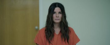 Movie still from “Ocean's Eight” (2018), directed by Gary Ross – A woman in an orange shirt is in an orange jail cell; Close Up shot, Over the shoulder angle