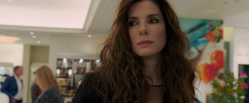 Movie still from “Ocean's Eight” (2018), directed by Gary Ross – A person with long brown hair; Close Up shot, Over the shoulder angle