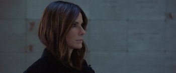 Movie still from “Ocean's Eight” (2018), directed by Gary Ross – A beautiful woman with long brown hair looking to the side; Close Up shot, Over the shoulder angle