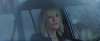 Movie still from “Ocean's Eight” (2018), directed by Gary Ross – A person sitting in a car; Close Up shot, Over the shoulder angle