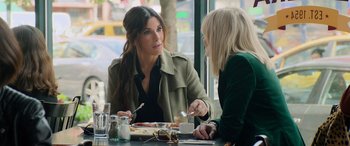 Movie still from “Ocean's Eight” (2018), directed by Gary Ross – Two women sitting at a table with a plate of food; Medium shot, Over the shoulder angle