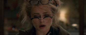 Movie still from “Ocean's Eight” (2018), directed by Gary Ross – A person wearing glasses; Close Up shot, Over the shoulder angle