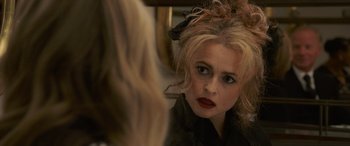 Movie still from “Ocean's Eight” (2018), directed by Gary Ross – A woman looking at her reflection in a mirror; Close Up shot, Over the shoulder angle