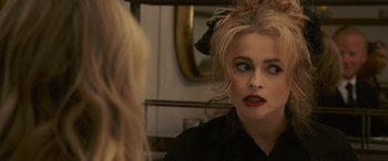 Movie still from “Ocean's Eight” (2018), directed by Gary Ross – A woman looking at her reflection in a mirror; Close Up shot, Over the shoulder angle
