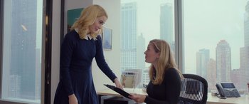 Movie still from “Ocean's Eight” (2018), directed by Gary Ross – Two women are talking in an office setting; Medium shot, Over the shoulder angle