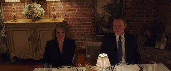 Movie still from “Ocean's Eight” (2018), directed by Gary Ross – A man and a woman sitting at a dinner table; Medium shot, High angle