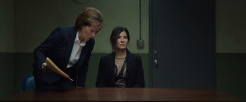 Movie still from “Ocean's Eight” (2018), directed by Gary Ross – A woman sitting at a table in front of another woman; Medium shot, Over the shoulder angle