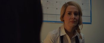 Movie still from “Ocean's Eight” (2018), directed by Gary Ross – A woman in a white shirt is looking at the camera; Close Up shot, Over the shoulder angle