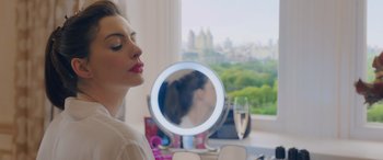 Movie still from “Ocean's Eight” (2018), directed by Gary Ross – A beautiful woman sitting in front of a round mirror; Close Up shot, Over the shoulder angle