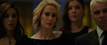 Movie still from “Ocean's Eight” (2018), directed by Gary Ross – Two women in black dresses one of which is wearing a black dress; Close Up shot, Over the shoulder angle