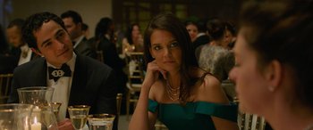 Movie still from “Ocean's Eight” (2018), directed by Gary Ross – A woman sitting at a table in front of a group of people; Close Up shot, Over the shoulder angle