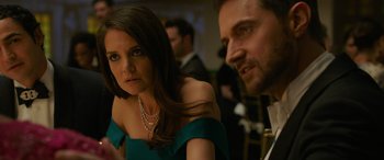 Movie still from “Ocean's Eight” (2018), directed by Gary Ross – A woman in a green dress and a man in a black suit; Close Up shot, Over the shoulder angle