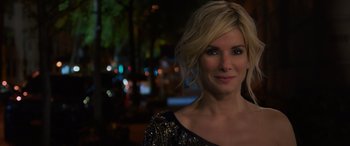 Movie still from “Ocean's Eight” (2018), directed by Gary Ross – A woman with blonde hair wearing a black and gold dress; Close Up shot, Over the shoulder angle