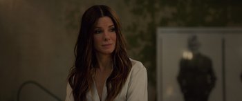 Movie still from “Ocean's Eight” (2018), directed by Gary Ross – A woman in a white shirt is looking at the camera; Close Up shot, Over the shoulder angle