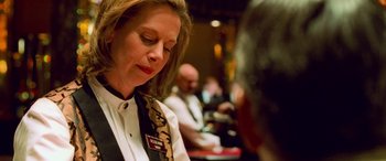 Movie still from “Ocean's Eleven” (2001), directed by Steven Soderbergh – A woman in a white shirt and a black and red tie; Close Up shot, Over the shoulder angle