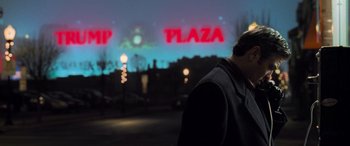 Movie still from “Ocean's Eleven” (2001), directed by Steven Soderbergh – A man standing in a parking lot at night; Wide shot, Over the shoulder angle