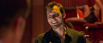 Movie still from “Ocean's Eleven” (2001), directed by Steven Soderbergh – A man with a goatee smiling for the camera; Close Up shot, Low angle