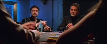 Movie still from “Ocean's Eleven” (2001), directed by Steven Soderbergh – A group of men sitting at a table playing a game; Medium shot, Low angle