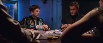 Movie still from “Ocean's Eleven” (2001), directed by Steven Soderbergh – A group of men sitting at a table playing cards; Medium shot, Over the shoulder angle