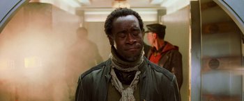 Movie still from “Ocean's Eleven” (2001), directed by Steven Soderbergh – A man in a jacket and scarf is looking down; Close Up shot, Low angle