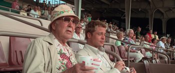 Movie still from “Ocean's Eleven” (2001), directed by Steven Soderbergh – Two men are sitting in the stands at a baseball game; Medium shot, Over the shoulder angle