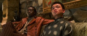 Movie still from “Ocean's Eleven” (2001), directed by Steven Soderbergh – Two men are standing next to each other in front of a painting; Medium shot, Low angle